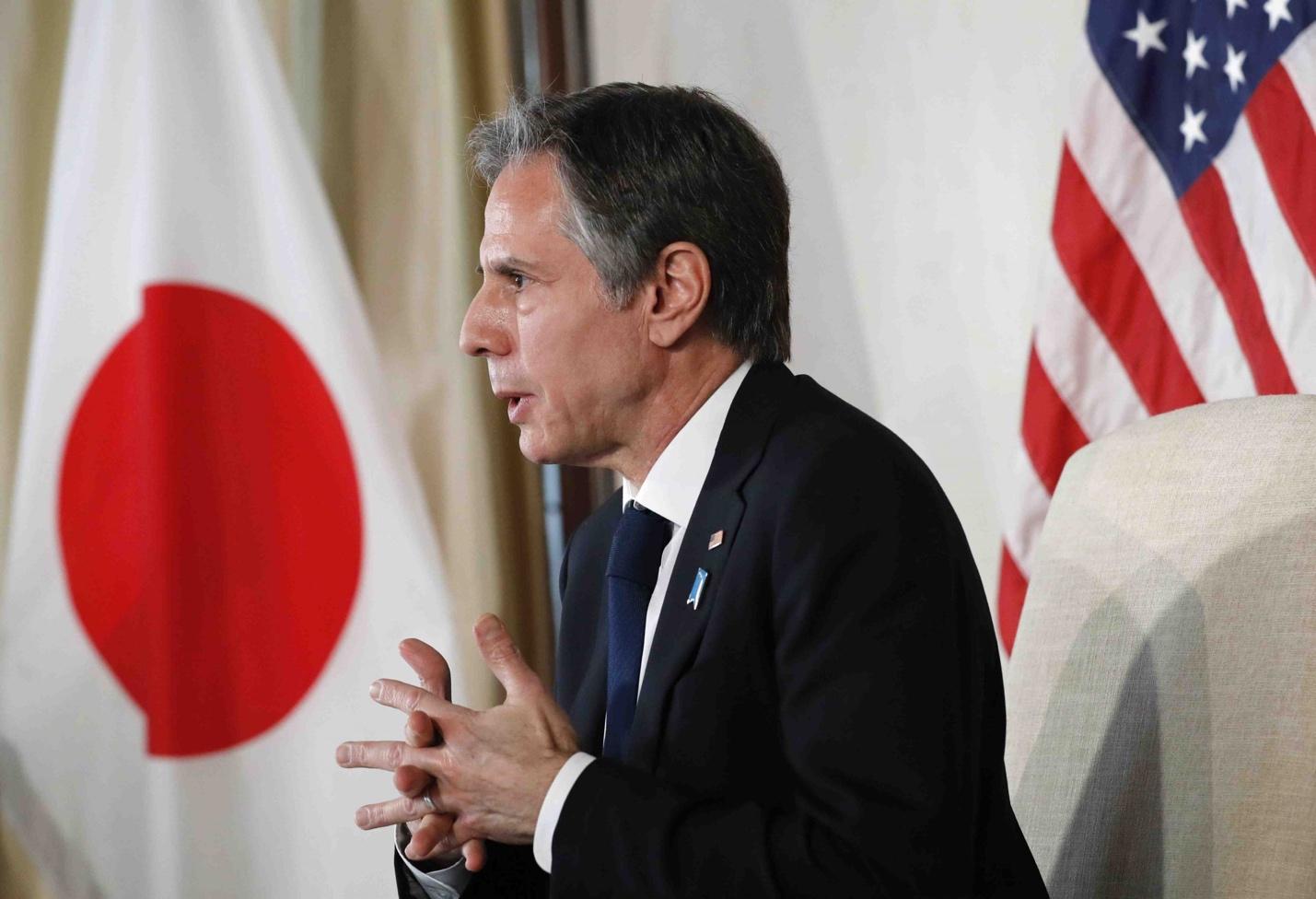 A person in a suit speaking to a group of flags

Description automatically generated with low confidence