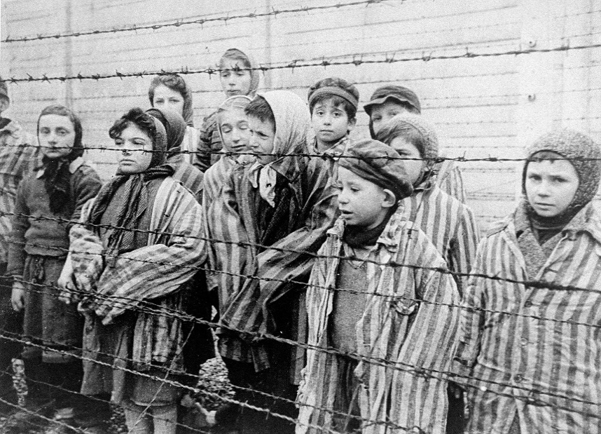 A group of people standing behind a fence

Description automatically generated with low confidence