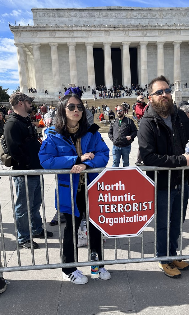 A person holding a sign

Description automatically generated with medium confidence