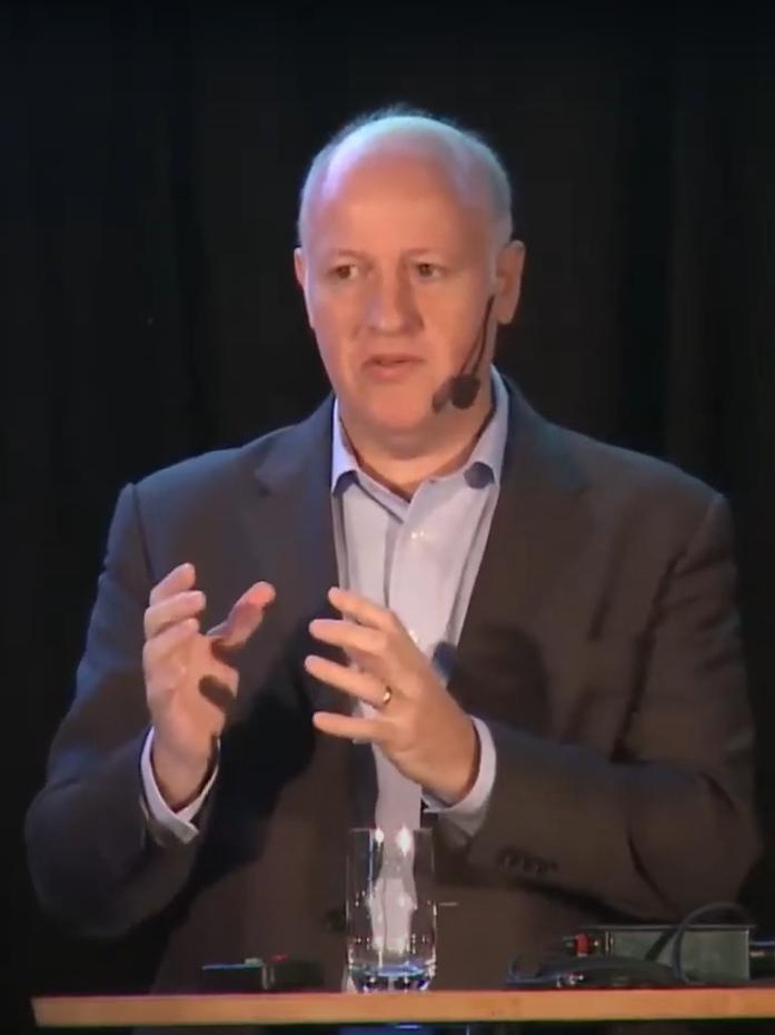 A person speaking at a podium

Description automatically generated with medium confidence
