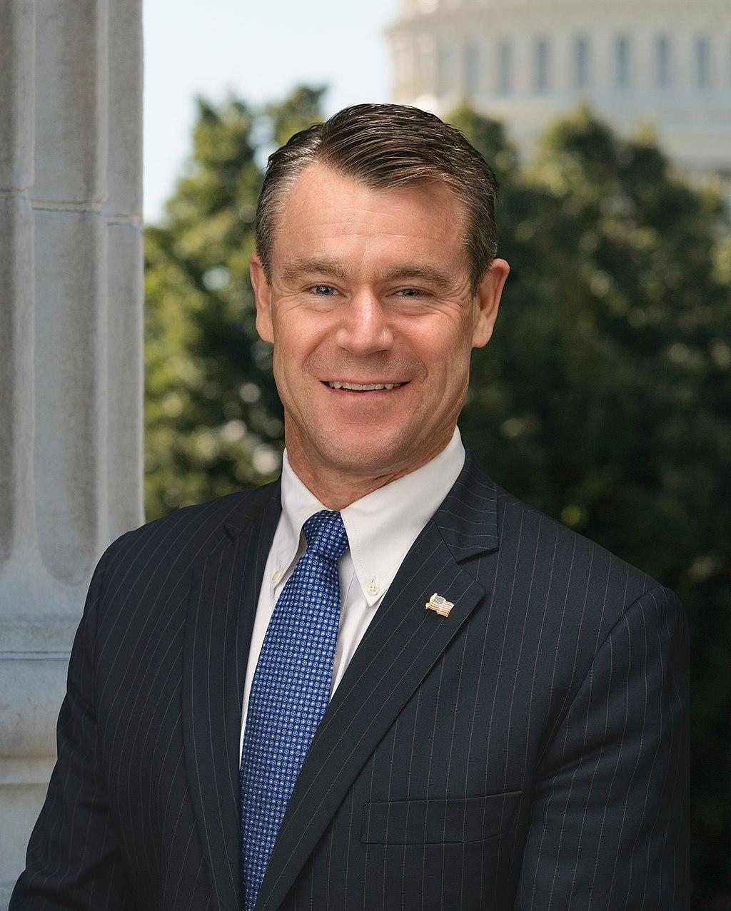 A person in a suit and tie

Description automatically generated with medium confidence