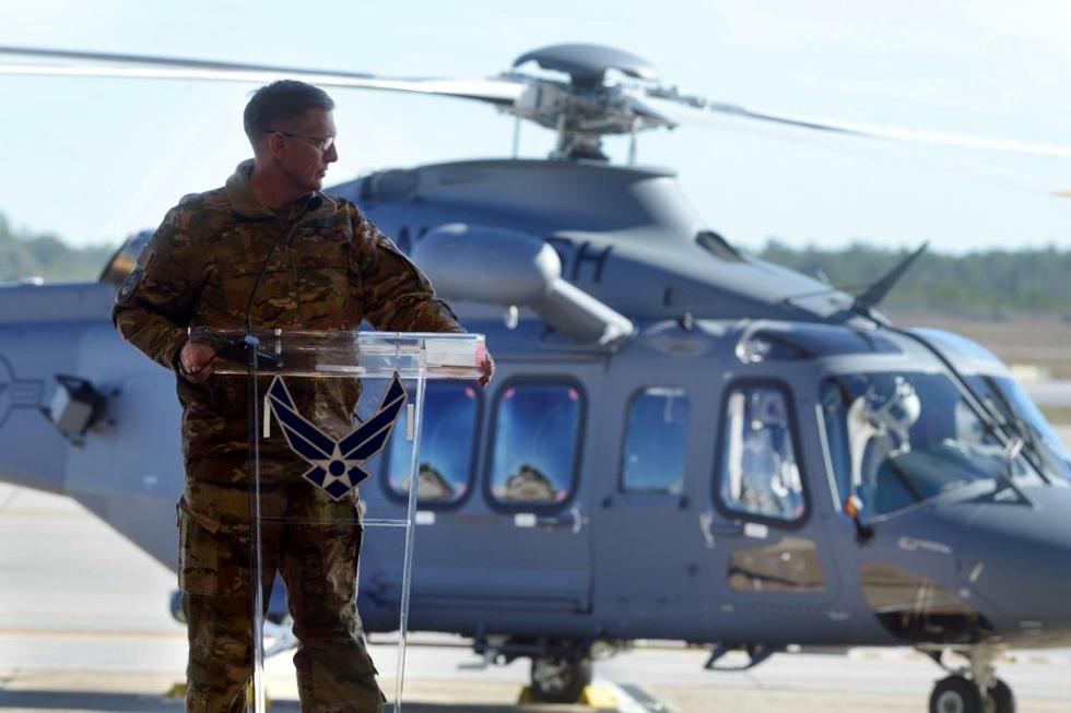 A person standing next to a helicopter

Description automatically generated