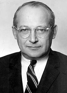 A person wearing glasses and a suit

Description automatically generated with medium confidence