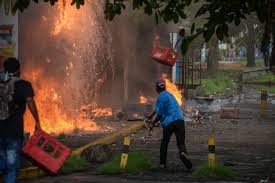 A picture containing fire, outdoor, street, tear gas

Description automatically generated