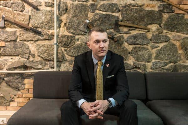 Mr. Hudymenko in his office in Kyiv, where the walls are adorned with axes and a crossbow. He and members of his nationalist group are arming themselves for battle against Russia.