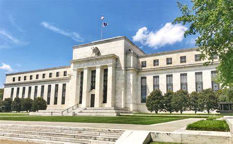 A large building with columns and a flag on top

Description automatically generated with low confidence
