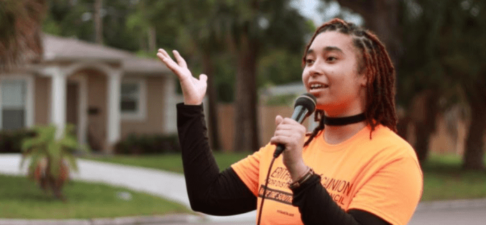 A person holding a microphone Description automatically generated with medium confidence