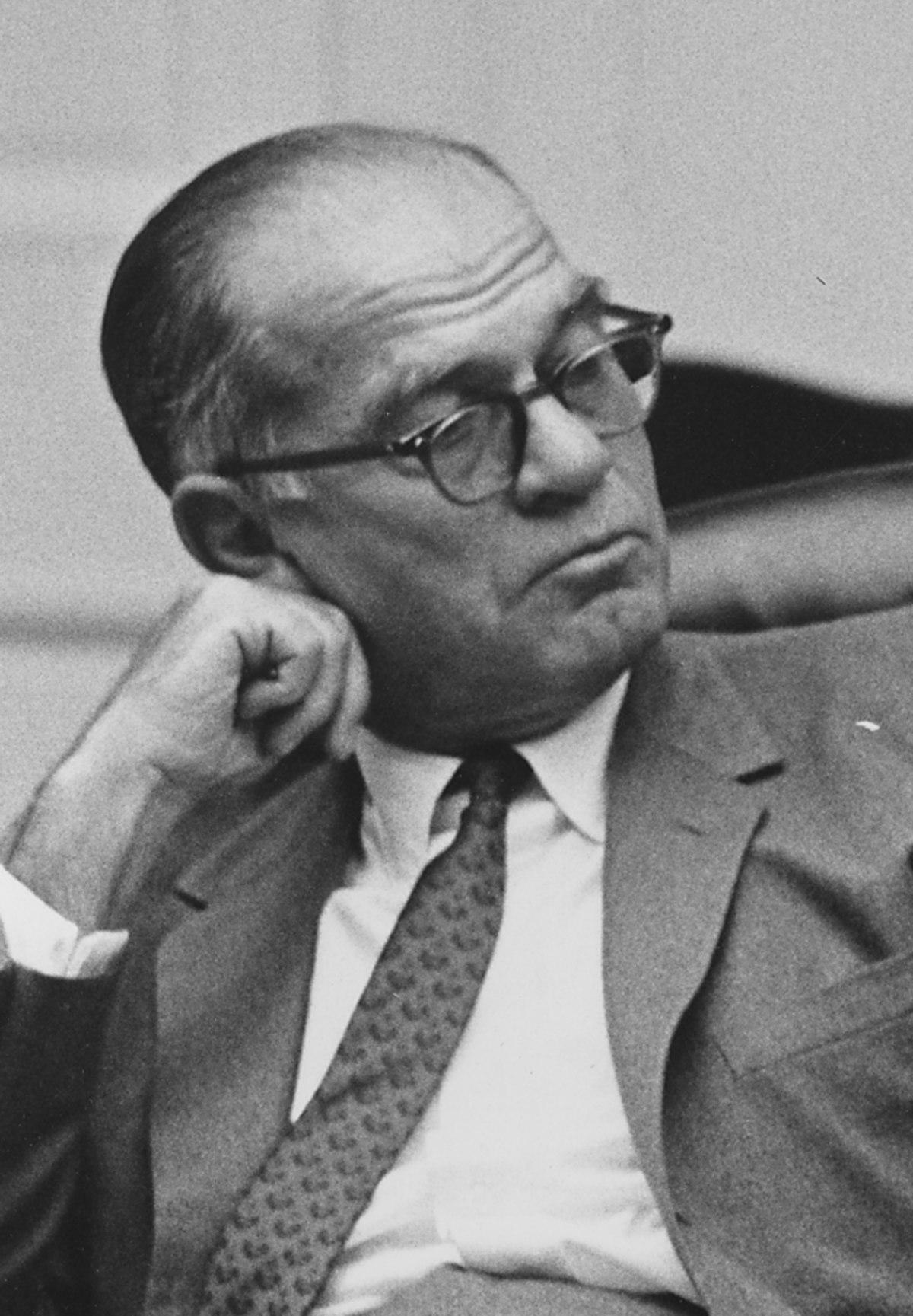 A person wearing glasses and a suit

Description automatically generated with low confidence