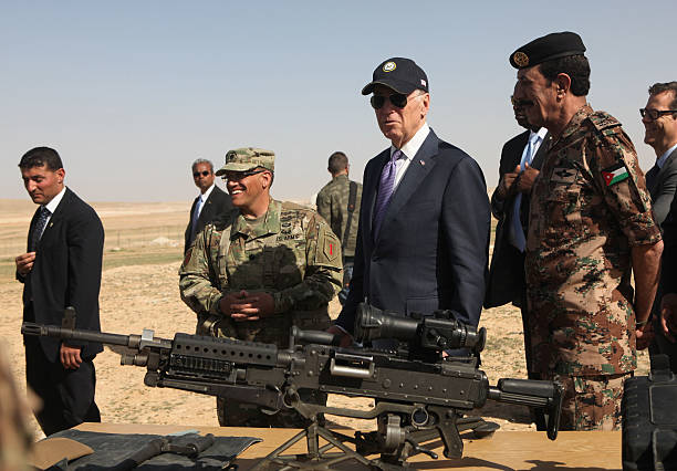 Vice President Joe Biden reviews weapons and troops during a visit with Jordan's King Abdullah at a joint Jordanian-American training center on March...