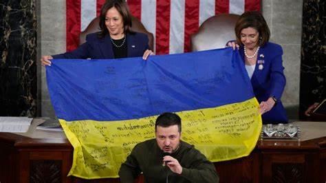 A group of people holding a flag

Description automatically generated with medium confidence
