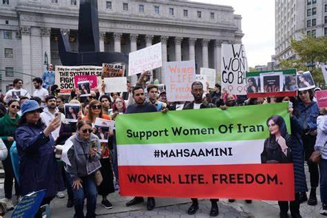 A group of people holding signs

Description automatically generated