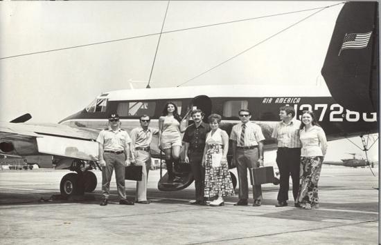 A group of people standing in front of an airplane

Description automatically generated with medium confidence