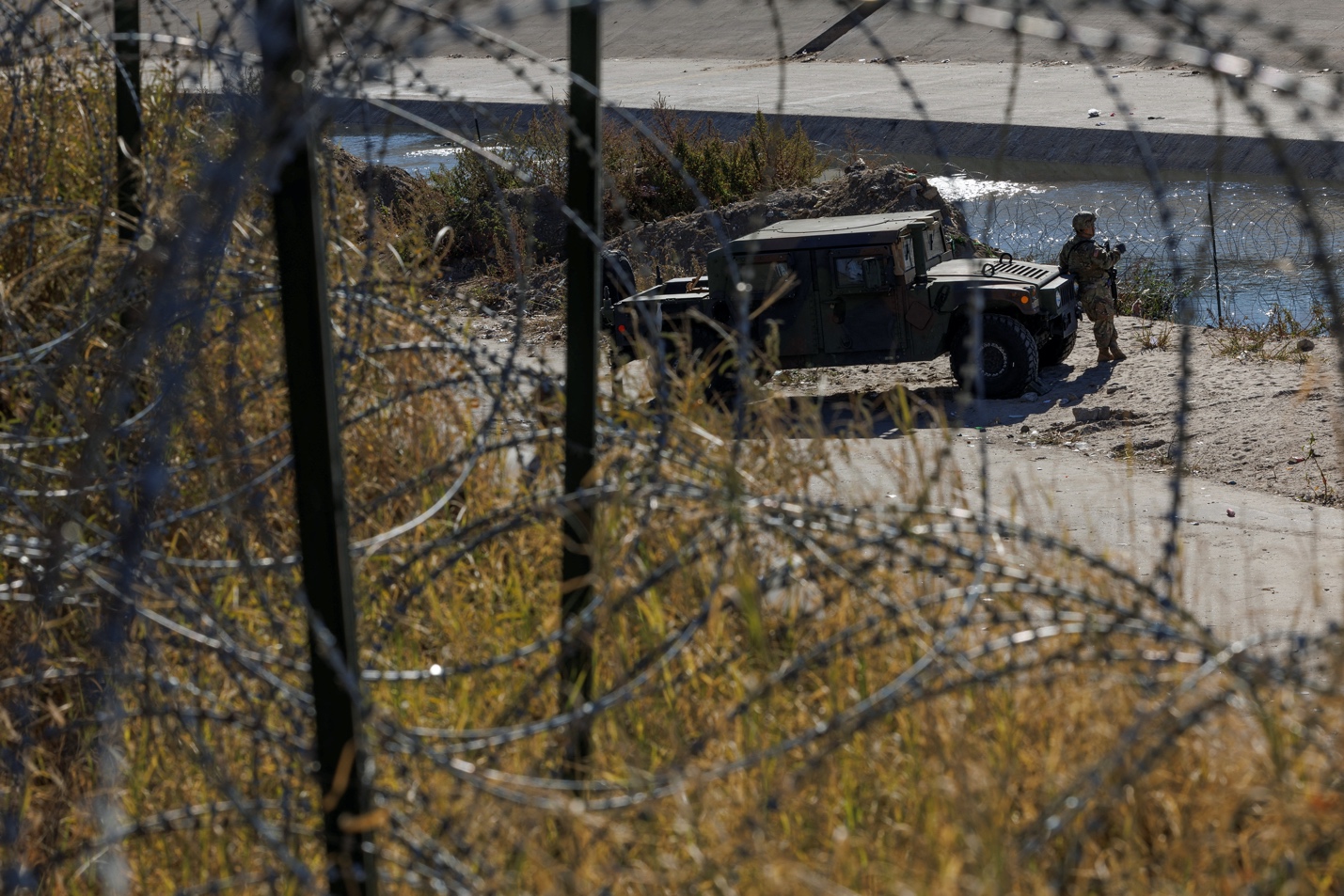 A member of the Texas National Guard at the Rio Bravo river, the border between Mexico and the U.S., as seen from El Paso