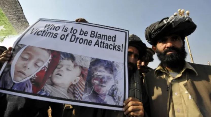 A group of men holding a sign

Description automatically generated