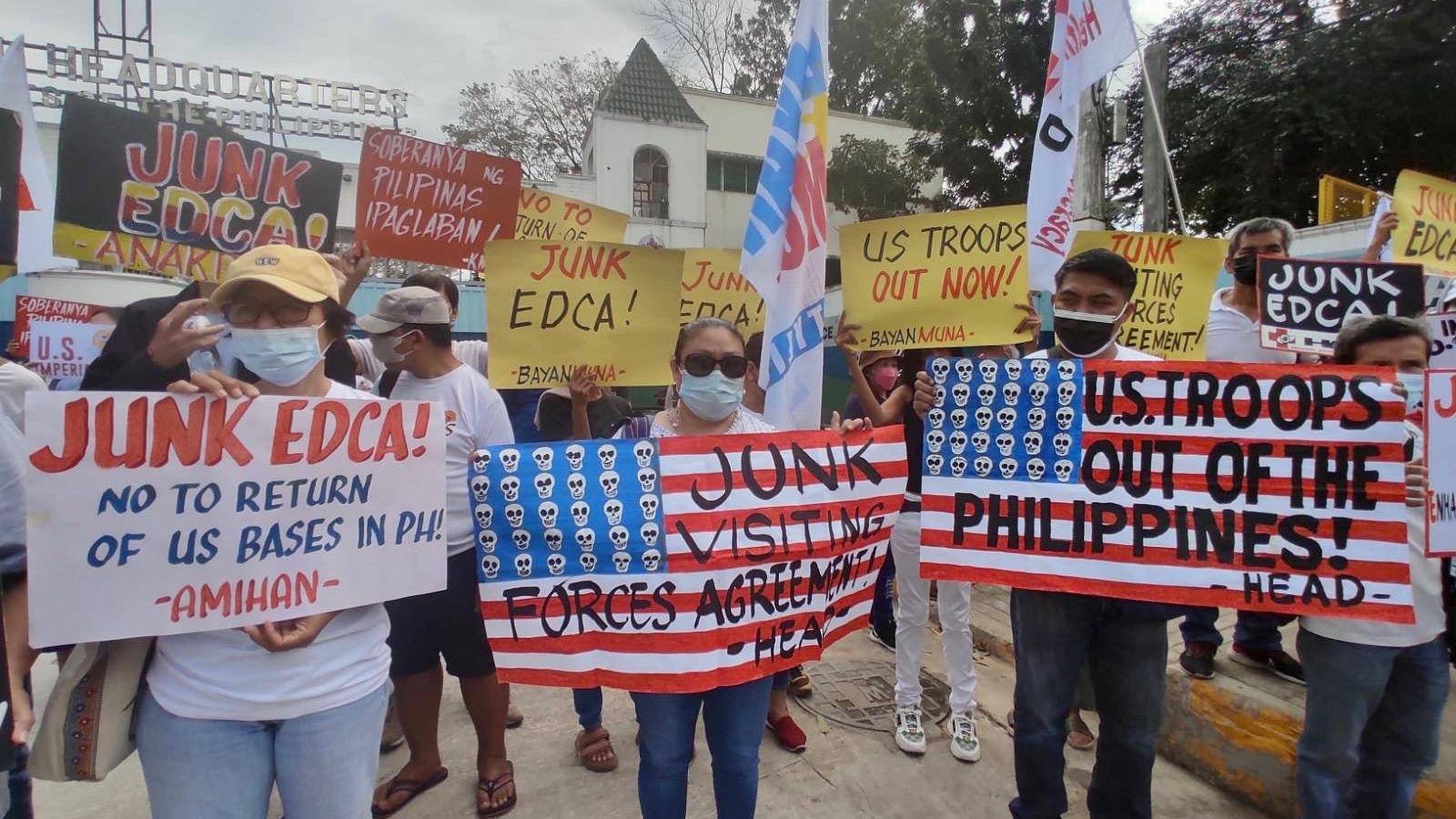 A group of people holding signs

Description automatically generated
