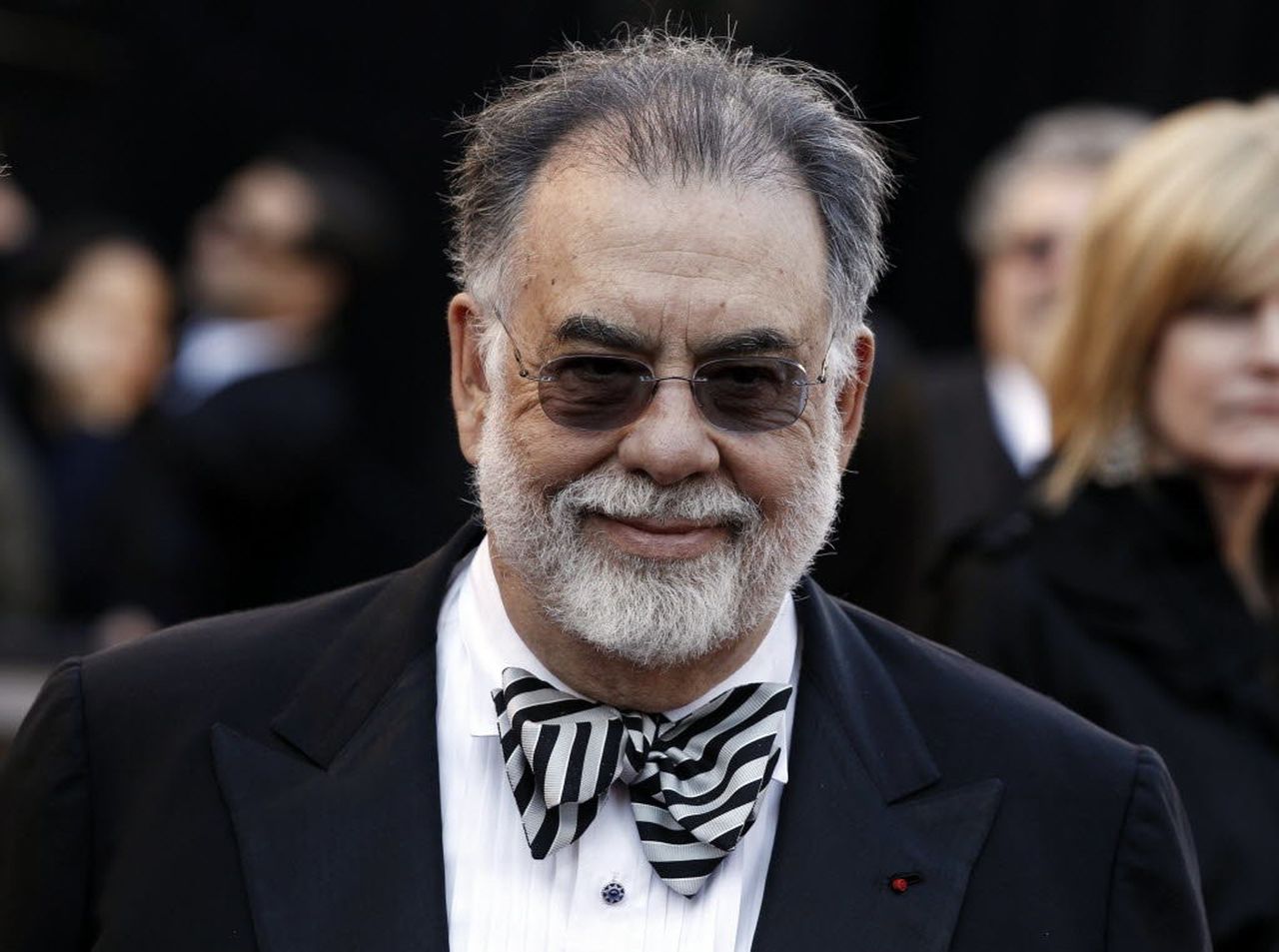 A person in a suit and sunglasses

Description automatically generated with low confidence