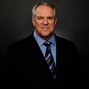 A person in a suit and tie

Description automatically generated with medium confidence