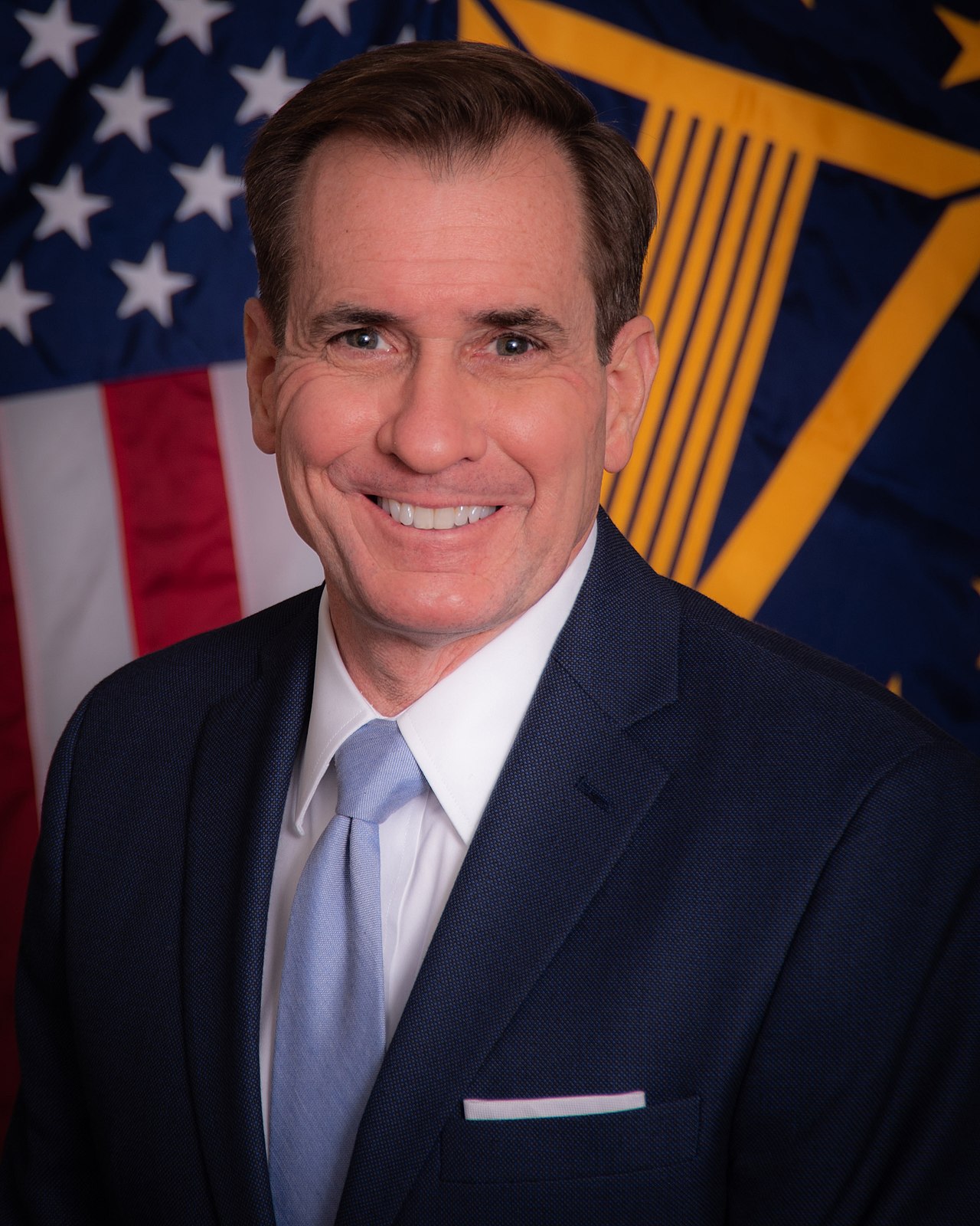 A person in a suit and tie

Description automatically generated with medium confidence