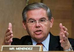 A person in a suit and tie speaking at a podium

Description automatically generated with low confidence