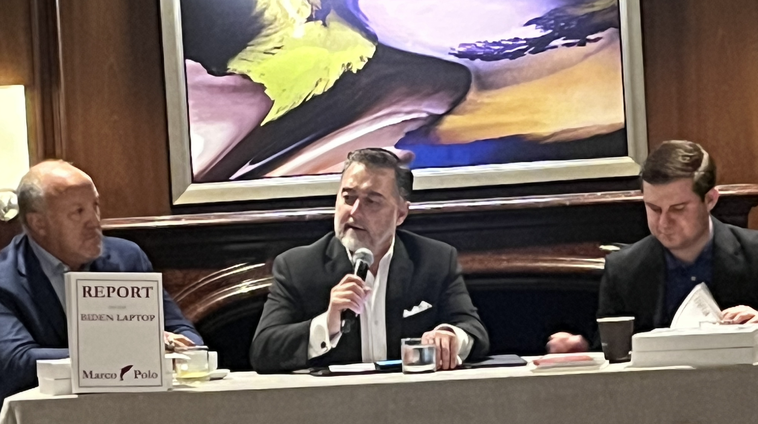 A person in a suit speaking into a microphone

Description automatically generated with medium confidence