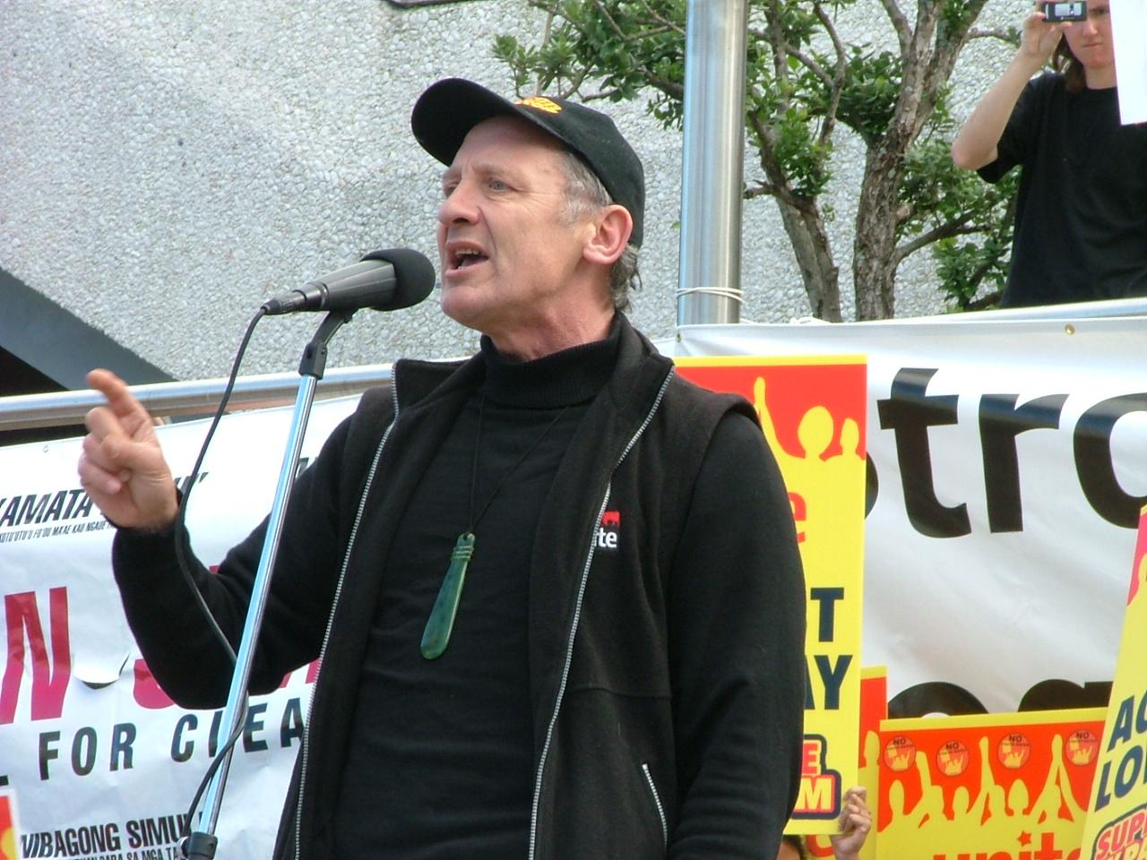 A person speaking into a microphone

Description automatically generated