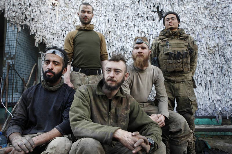 A group of men posing for a photo

Description automatically generated