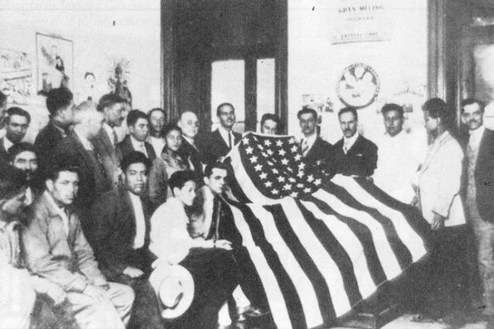 A group of people holding a flag

Description automatically generated with medium confidence