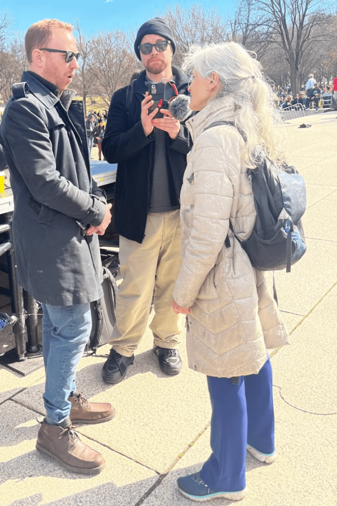 A group of people standing outside Description automatically generated with low confidence