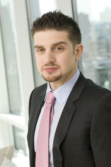 A person in a suit and tie

Description automatically generated with medium confidence