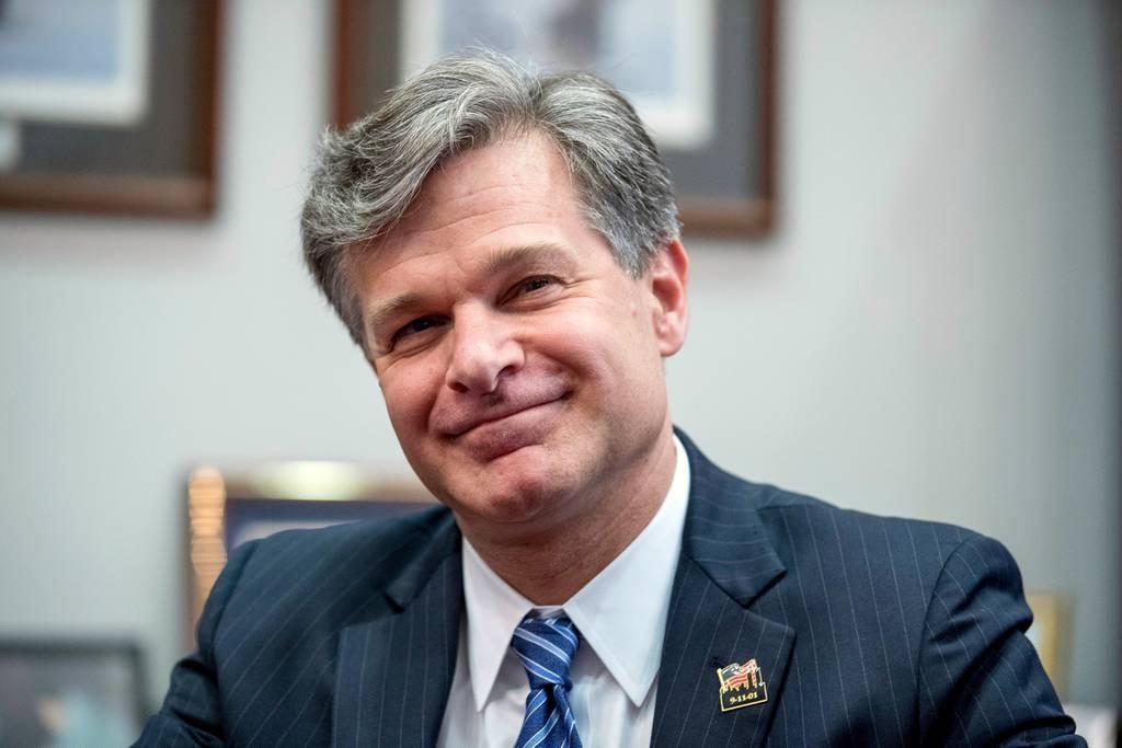 A person in a suit smiling

Description automatically generated