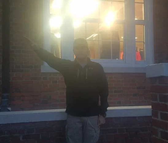 A person standing in front of a window

Description automatically generated