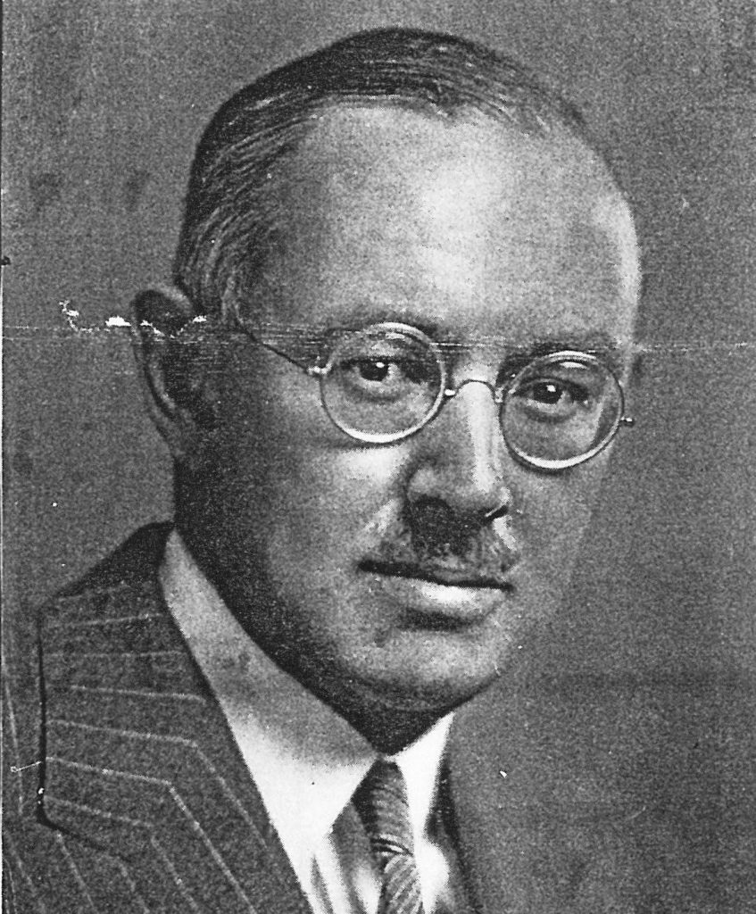 A person wearing glasses and a suit

Description automatically generated with low confidence
