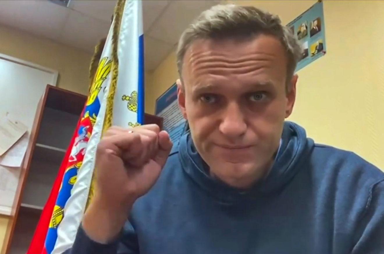 A person with his fist up in front of a flag

Description automatically generated with medium confidence