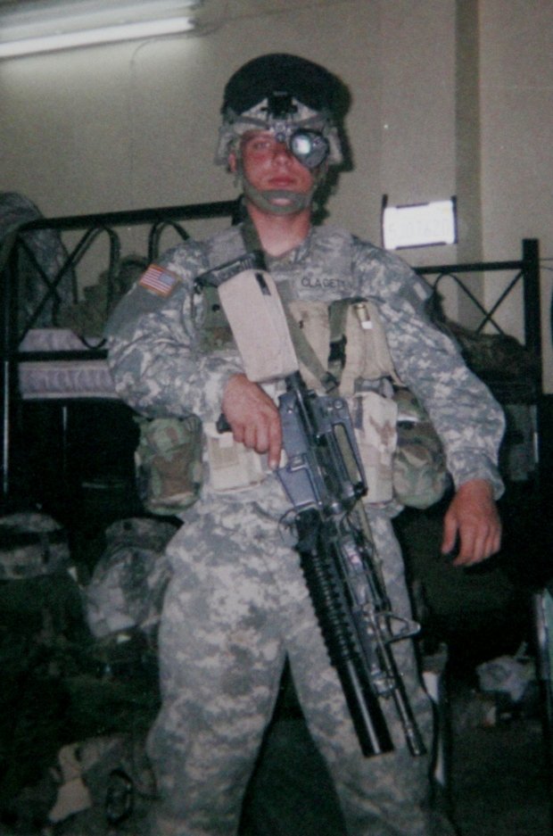 A soldier holding an object

Description automatically generated
