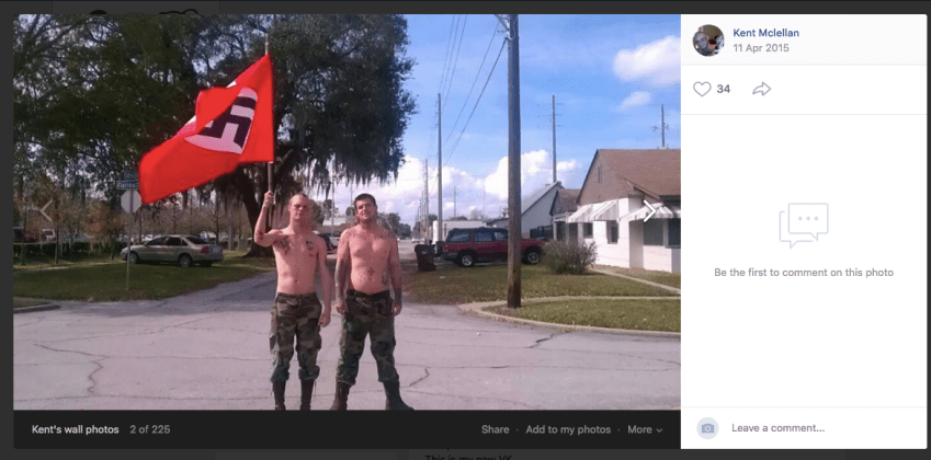 Two men standing in the street holding a flag

Description automatically generated with low confidence