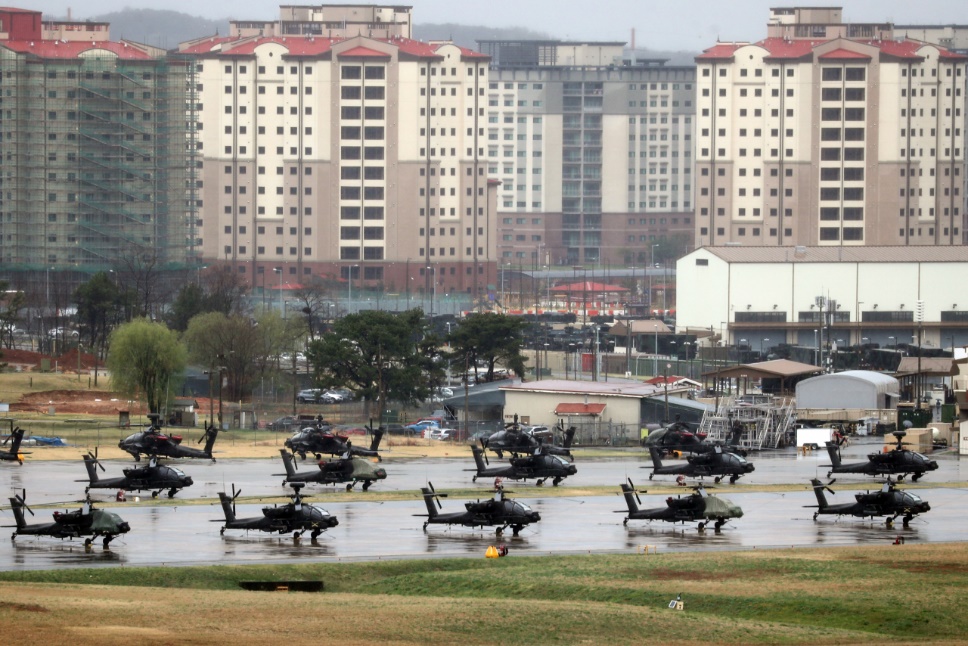 A group of helicopters on a wet road

Description automatically generated