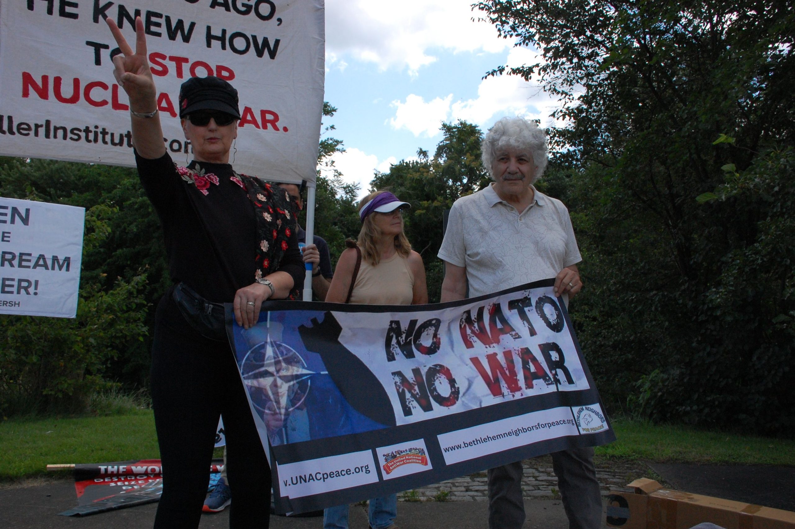 A group of people holding a banner

Description automatically generated
