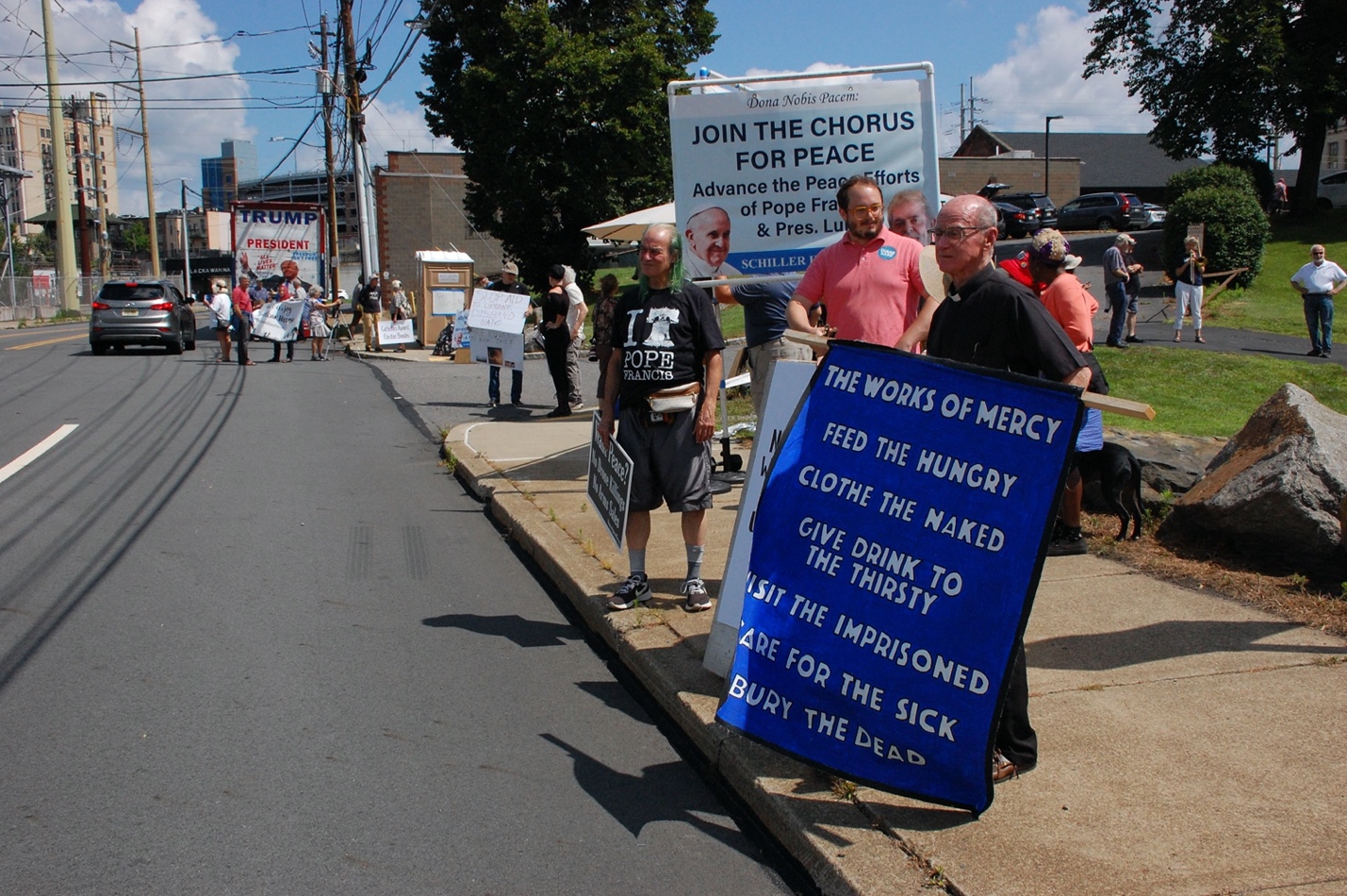 A group of people holding signs

Description automatically generated