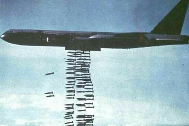 A jet dropping bombs into the air

Description automatically generated