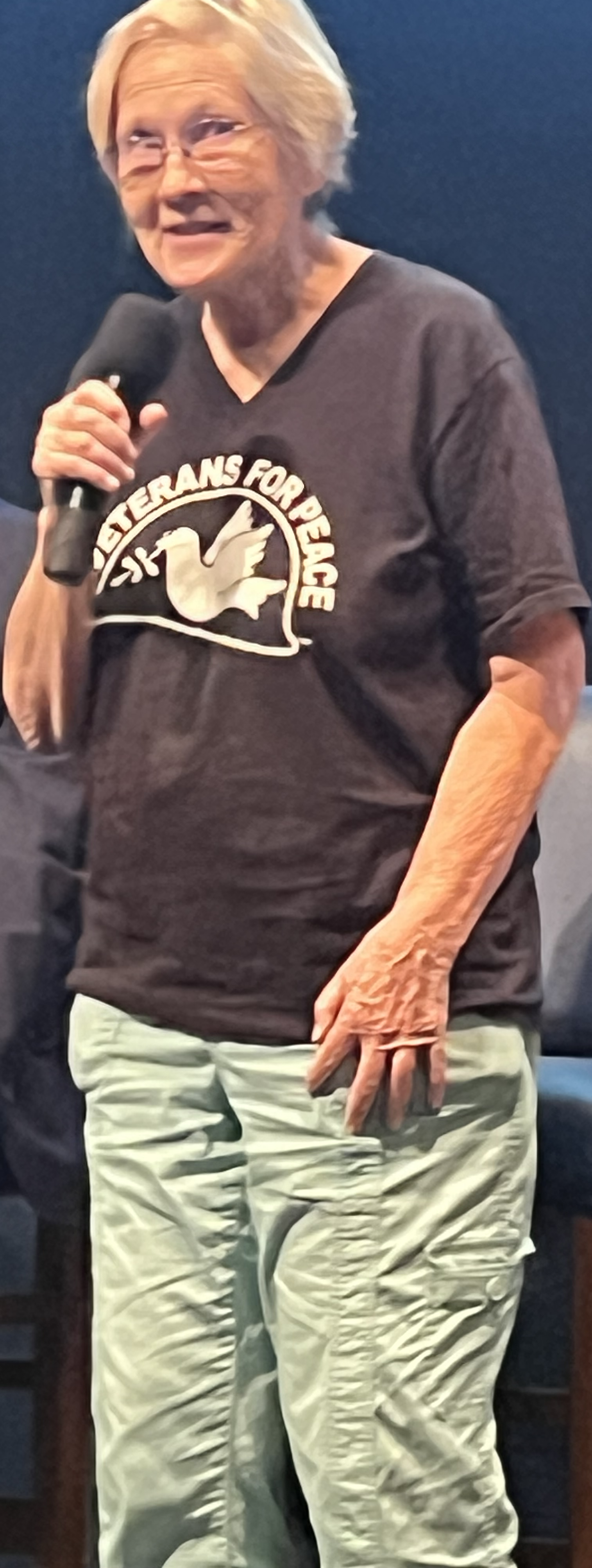 A person holding a microphone
Description automatically generated