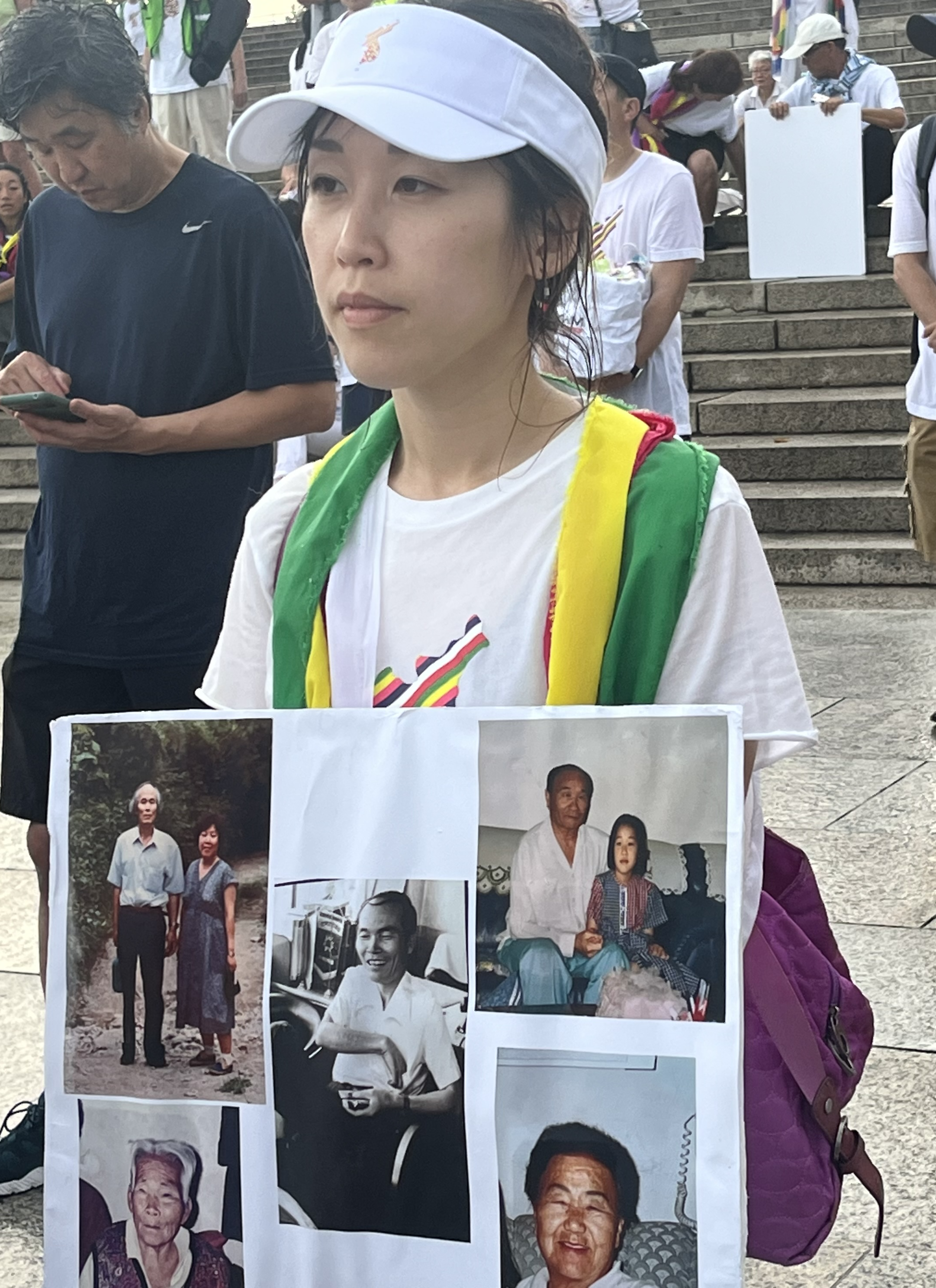 A person holding a sign with pictures

Description automatically generated