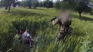 A person in a field with an object
Description automatically generated