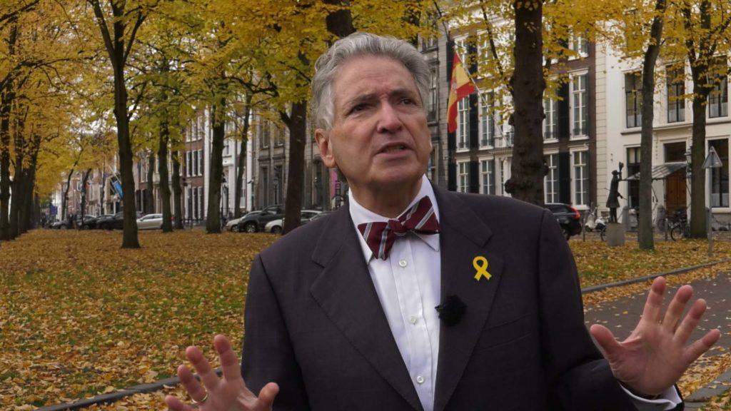 A person in a suit and bow tie
Description automatically generated