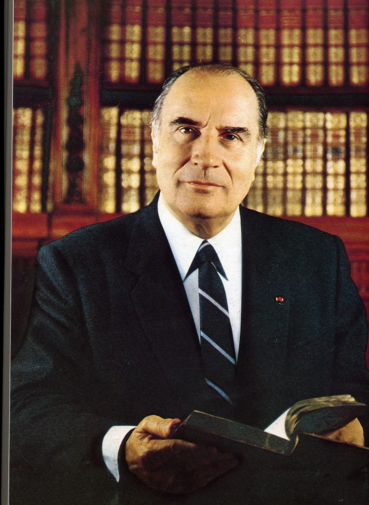 A person in a suit holding a book
Description automatically generated with medium confidence