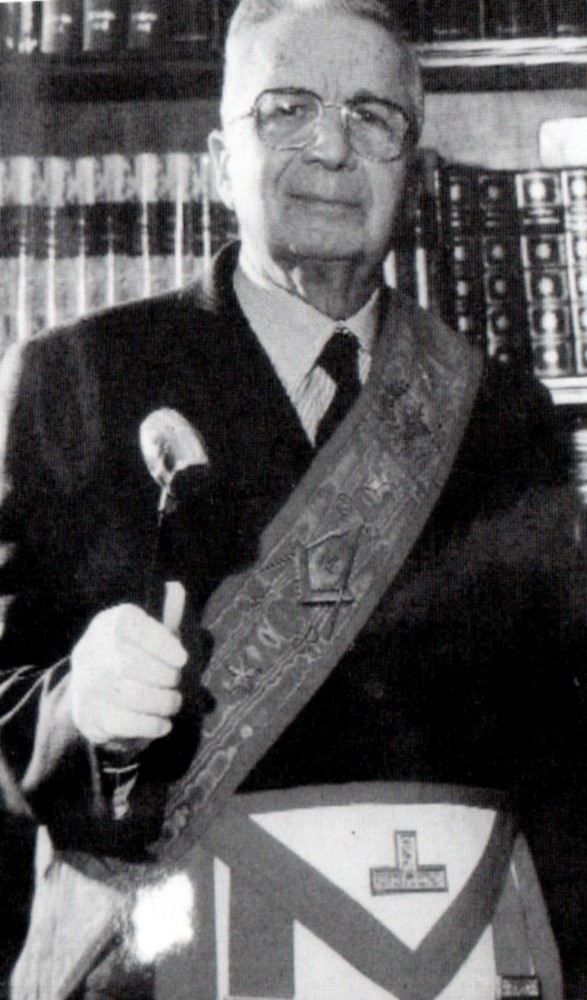 A person wearing a sash and holding a microphone
Description automatically generated with low confidence
