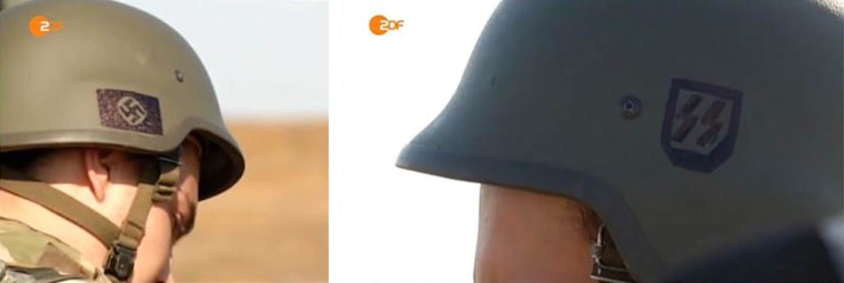 Ukrainian soldiers with Nazi symbols on their helmets, including the swastika.