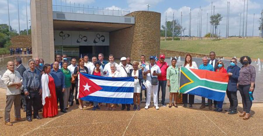 A group of people holding flags

Description automatically generated