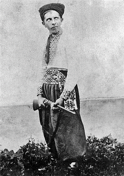 A person in traditional clothing holding a sword Description automatically generated