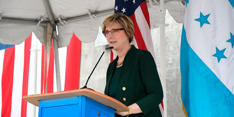A person standing at a podium

Description automatically generated