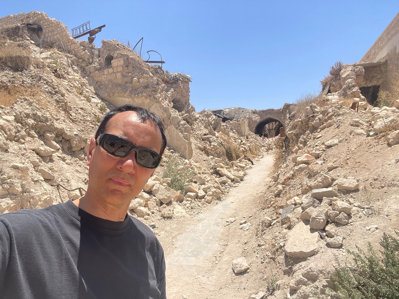 A person standing in a rocky area

Description automatically generated